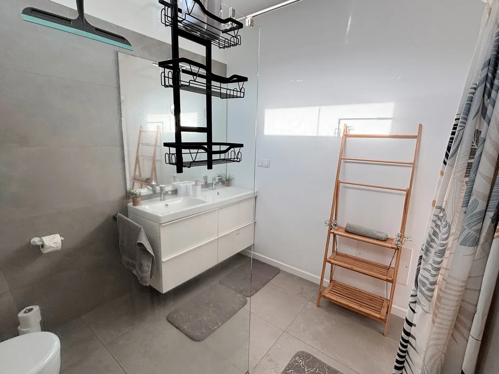 Modern bathroom with walk-in shower and towel ladder