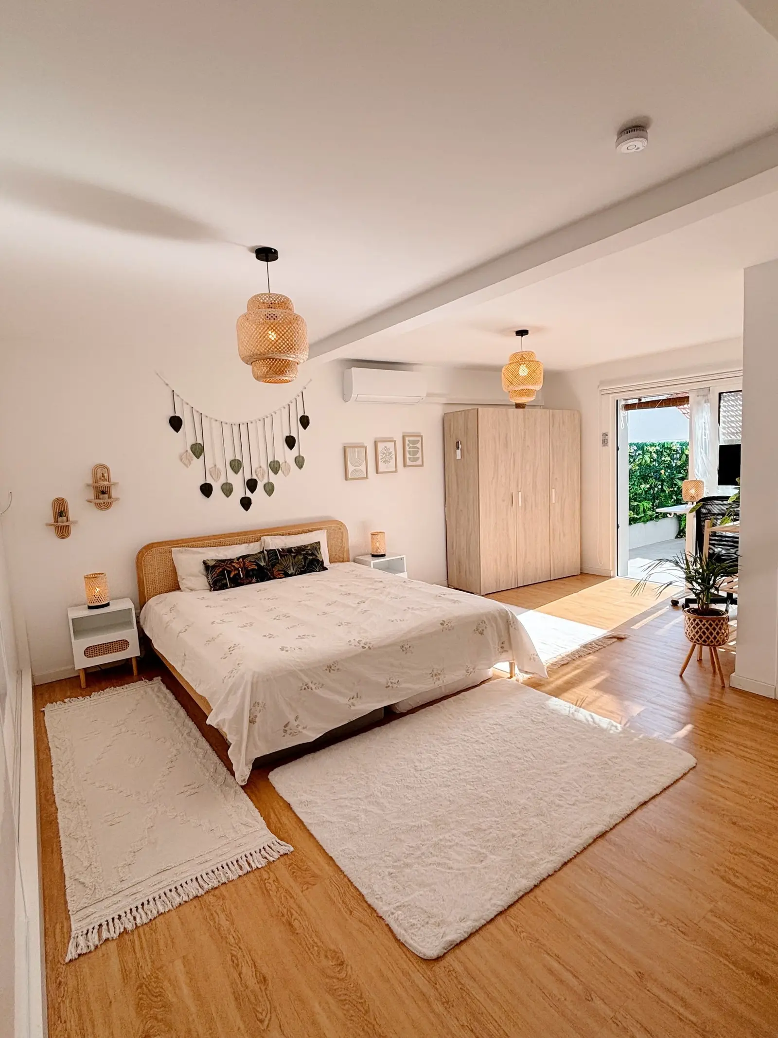 Large bedroom with double bed, rug and doors to the garden