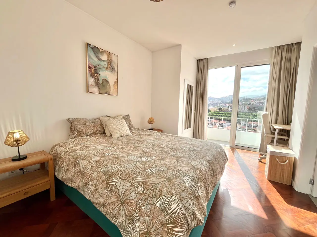 Double bedroom with sliding doors onto a balcony overlooking the city