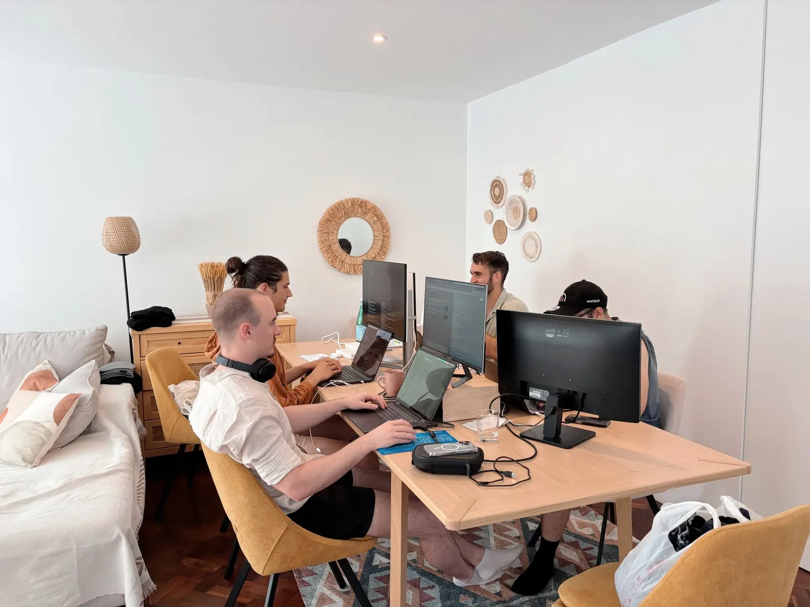 Residents working side by side at desks with external monitors
