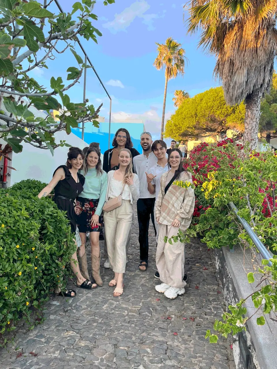 Friends posing in a flowering garden in Funchal