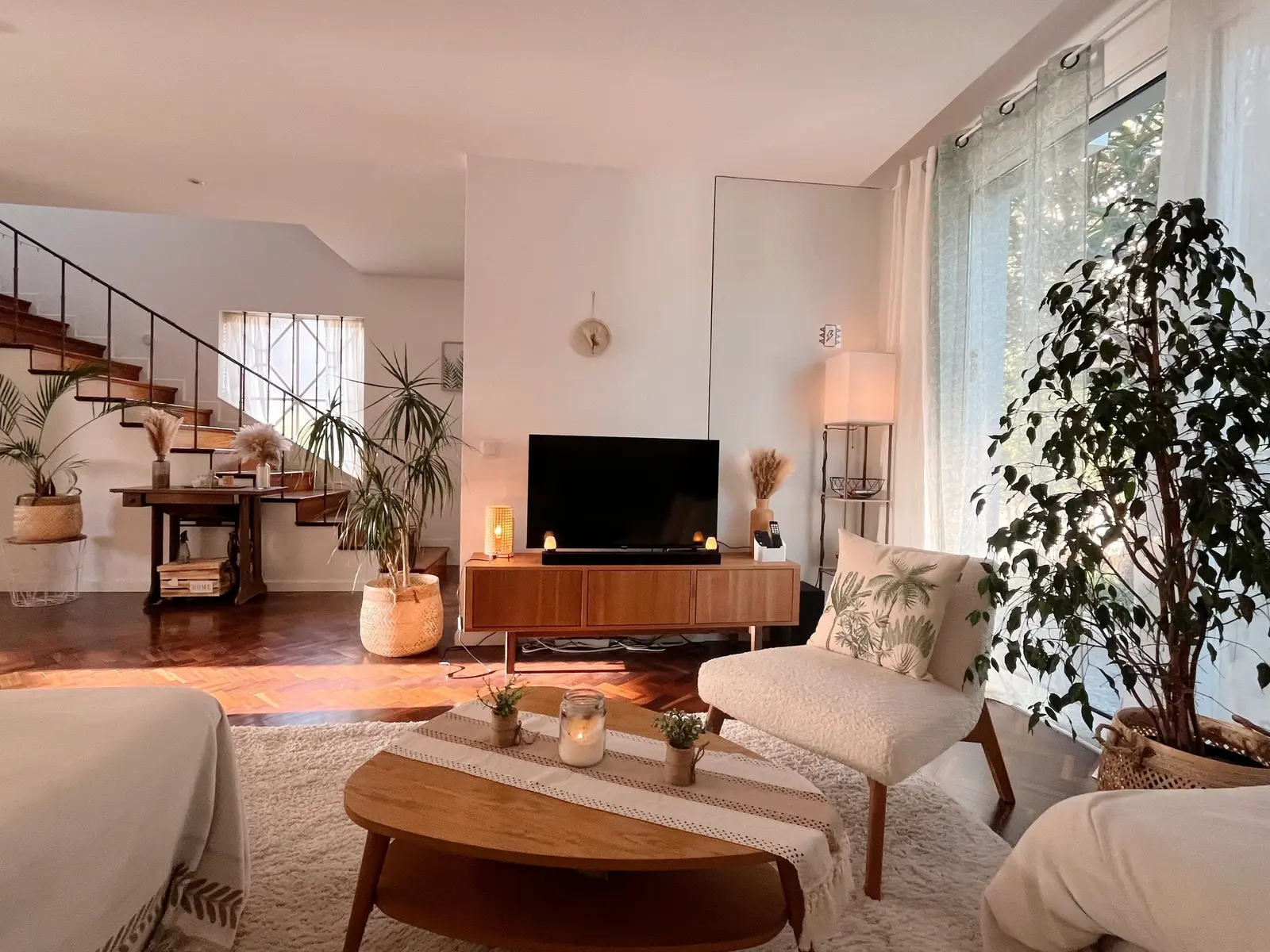 Living room with sofa, smart TV and staircase to the upper floors