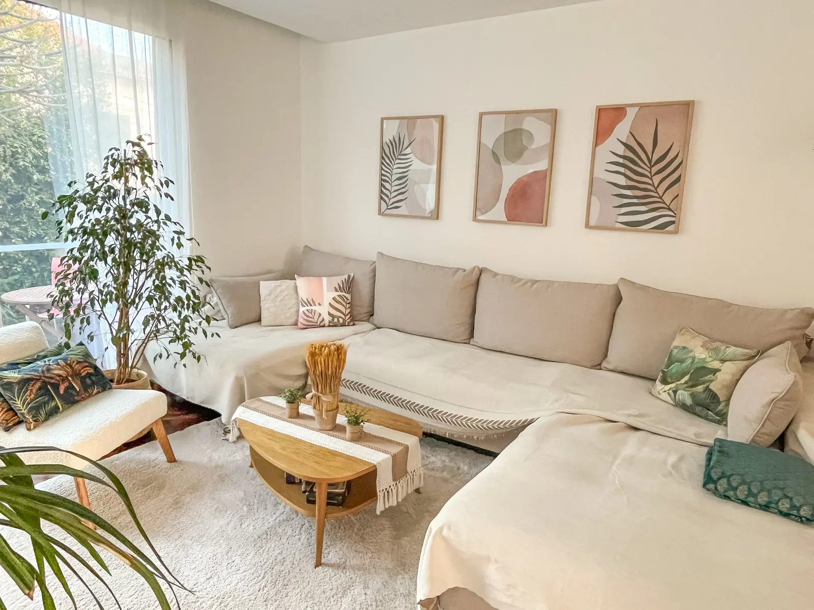 Corner sofa, coffee table and plants in the sunny lounge