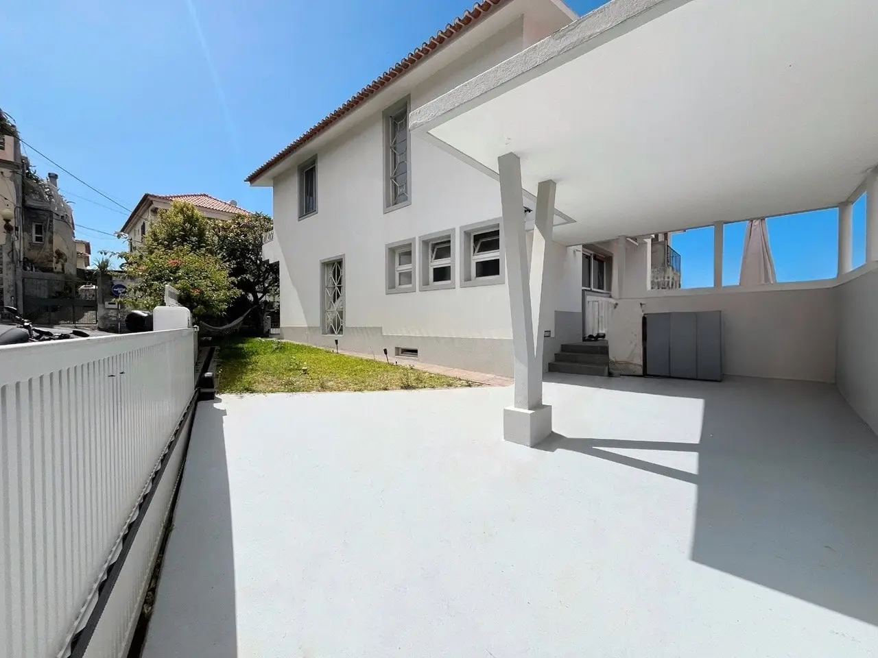Bright white terrace and garden wall of the Luzia House in the sunshine